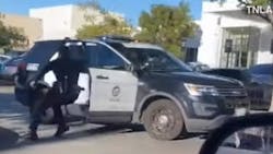 An LAPD officer tries to stop a cruiser that was rolling away while officers were trying to apprehend a shooting suspect Thursday. An LAPD officer tries to stop a cruiser that was rolling away while officers were trying to apprehend a shooting suspect Thursday.