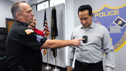 Springfield, MA, police sergeant John Wadlegger puts a police body camera on for state rep. Carlos Gonzalez to try on Oct. 22.