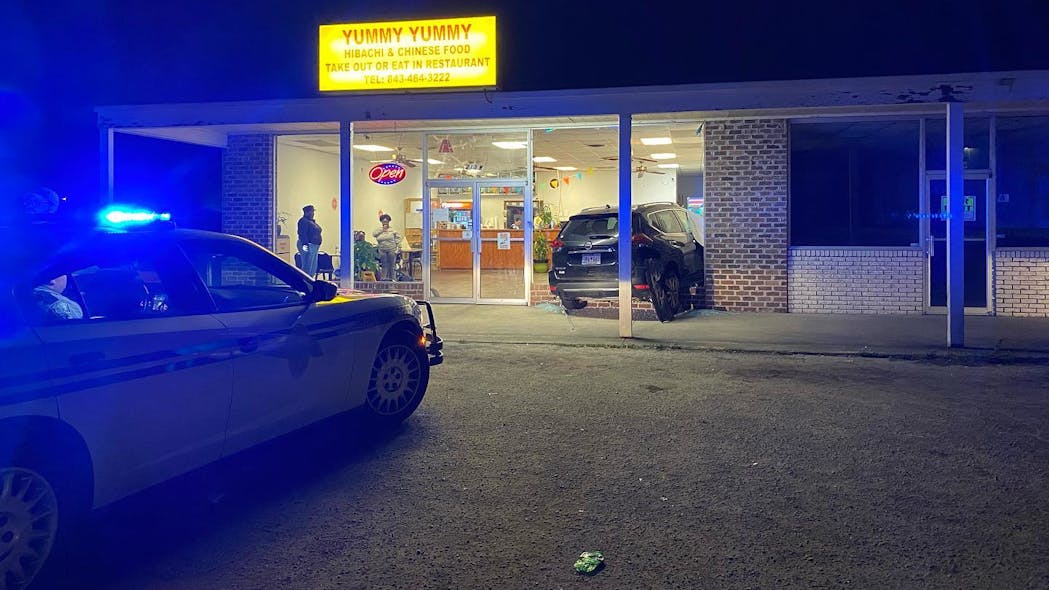 Two Mullins, SC, police officers suffered minor injuries after an SUV crashed into the restaurant where they were eating Monday.