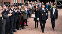 NYPD Chief of Department Kenneth Corey is saluted by dozens of uniformed officers and other officials during his walkout ceremony with his family Tuesday.