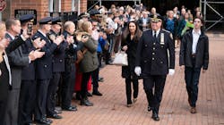 NYPD Chief of Department Kenneth Corey is saluted by dozens of uniformed officers and other officials during his walkout ceremony with his family Tuesday.
