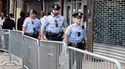 Philadelphia police officers patrol South Street on June 11, a week after a mass shooting on the popular street.