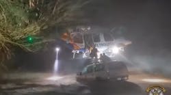 Arizona Department of Public Safety troopers use a helicopter to make a dramatic rescue of a stranded family&mdash;an 11-month-old child among them&mdash;clinging to the top of a car in floodwaters in Maricopa on Sept. 21.