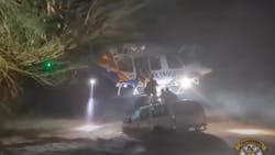 Arizona Department of Public Safety troopers use a helicopter to make a dramatic rescue of a stranded family&mdash;an 11-month-old child among them&mdash;clinging to the top of a car in floodwaters in Maricopa on Sept. 21.