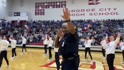Dodge City, KS, Police Cpl. Shane Harris, a school resource officer, impresses a crowd when he jumped in and began dancing with the Dodge City High School drill team during a recent assembly.