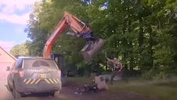 Vermont State Police troopers were trying to take a man into custody in Hardwick in June when his father got behind the controls of an excavator to swing the scoop at troopers in a wild attack.