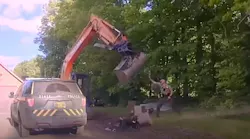 Vermont State Police troopers were trying to take a man into custody in Hardwick in June when his father got behind the controls of an excavator to swing the scoop at troopers in a wild attack.