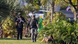 Police search for a suspect in a Miami mobile home neighborhood Monday. According to authorities, a Miami-Dade police officer was shot while trying to pull over a car. Police search for a suspect in a Miami mobile home neighborhood Monday. According to authorities, a Miami-Dade police officer was shot while trying to pull over a car.