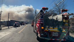 Firefighters battled a massive three-alarm fire that broke out at an NYPD auto impound yard in Brooklyn on Tuesday.