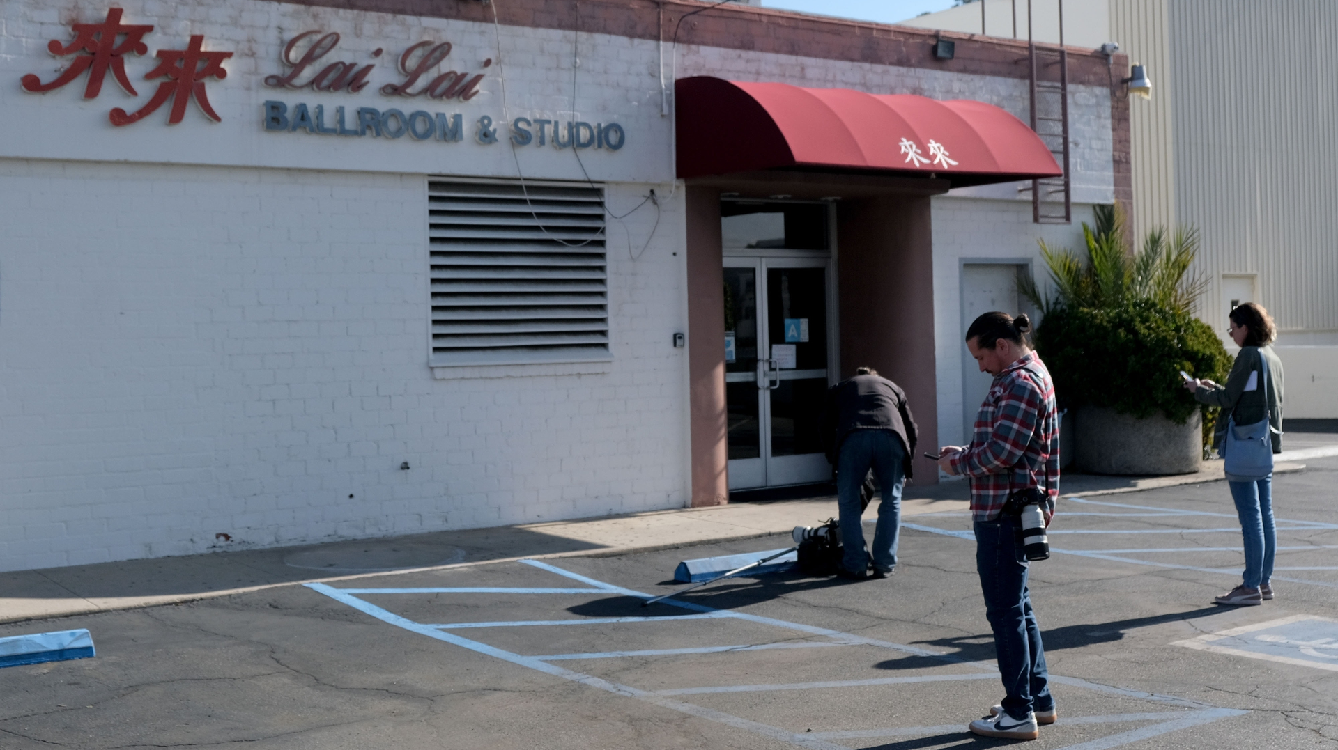 Reporters gather at Lai Lai Ballroom and Studio in Alhambra, CA, on Sunday.