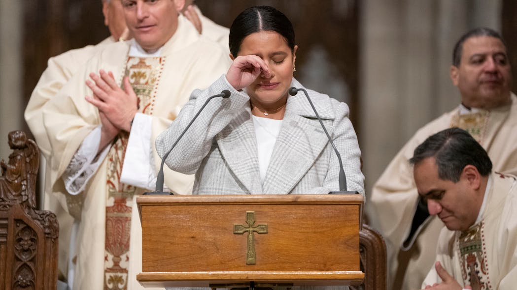 Dominque Luzuriaga, widow of NYPD Det. Jason Rivera, announces that she is pregnant with a child from her late husband at a memorial at St. Patrick's Cathedral in New York City on Saturday, marking one year since Rivera and his partner, Wilbert Mora, were gunned down in an ambush during a 2022 domestic violence incident. Dominque Luzuriaga, widow of NYPD Det. Jason Rivera, announces that she is pregnant with a child from her late husband at a memorial at St. Patrick's Cathedral in New York City on Saturday, marking one year since Rivera and his partner, Wilbert Mora, were gunned down in an ambush during a 2022 domestic violence incident.