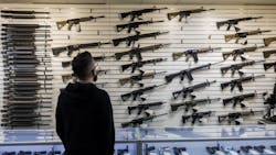 A customer looks at a selection of firearms, many of which fall under Illinois' new assault weapons ban, at R-Guns store on in Carpentersville. A customer looks at a selection of firearms, many of which fall under Illinois' new assault weapons ban, at R-Guns store on in Carpentersville.