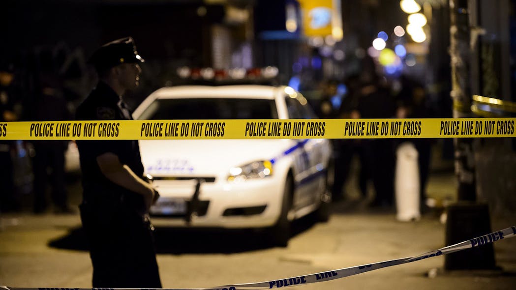 NYPD officers and detectives investigate a crime scene. NYPD officers and detectives investigate a crime scene.