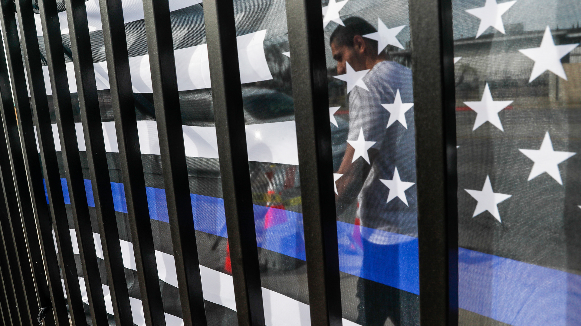 Small memorials, including a Thin Blue Line flag, remain days after dozens of Los Angeles County Sheriff recruits on a training run were struck by a man driving an SUV on Nov. 2 in Whittier.