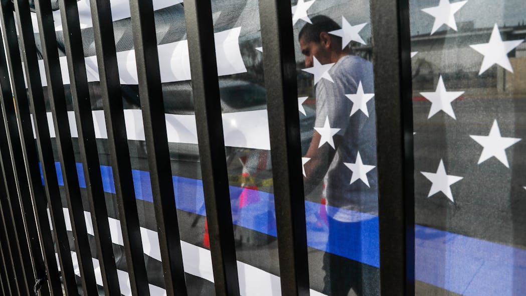 Small memorials, including a Thin Blue Line flag, remain days after dozens of Los Angeles County Sheriff recruits on a training run were struck by a man driving an SUV on Nov. 2 in Whittier.