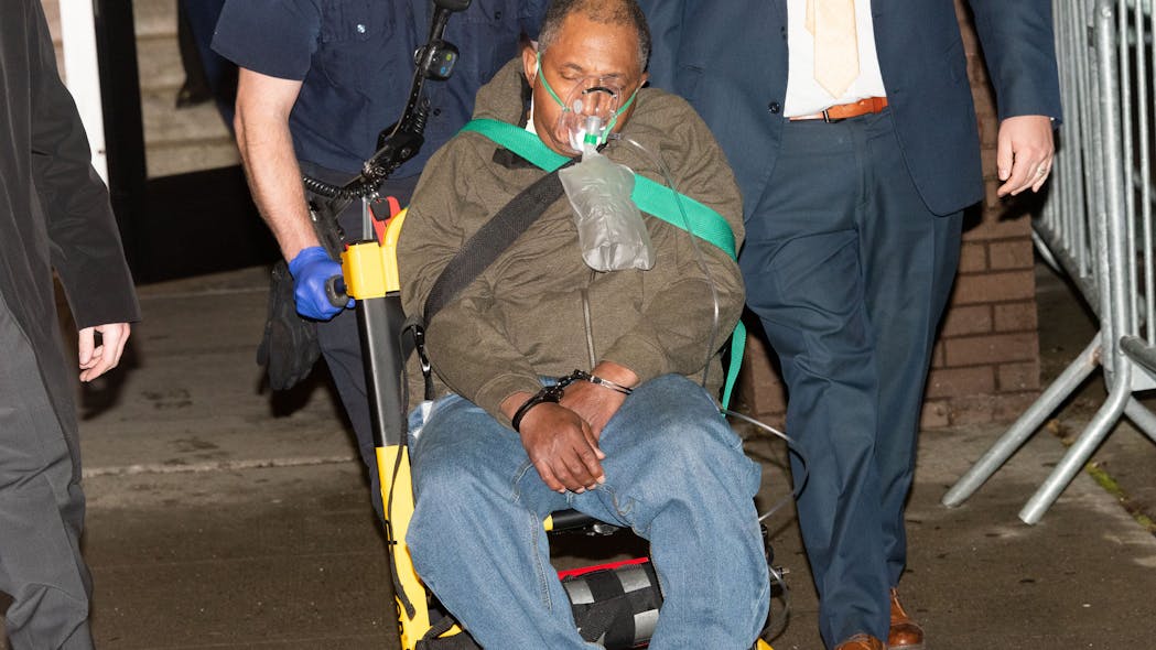 Larry Atkinson, 64, is taken to an ambulance from the New York Police Department's 50th Precinct stationhouse in the Bronx, on Jan. 23, 2023, after being charged with a 1994 double murder, in New York.