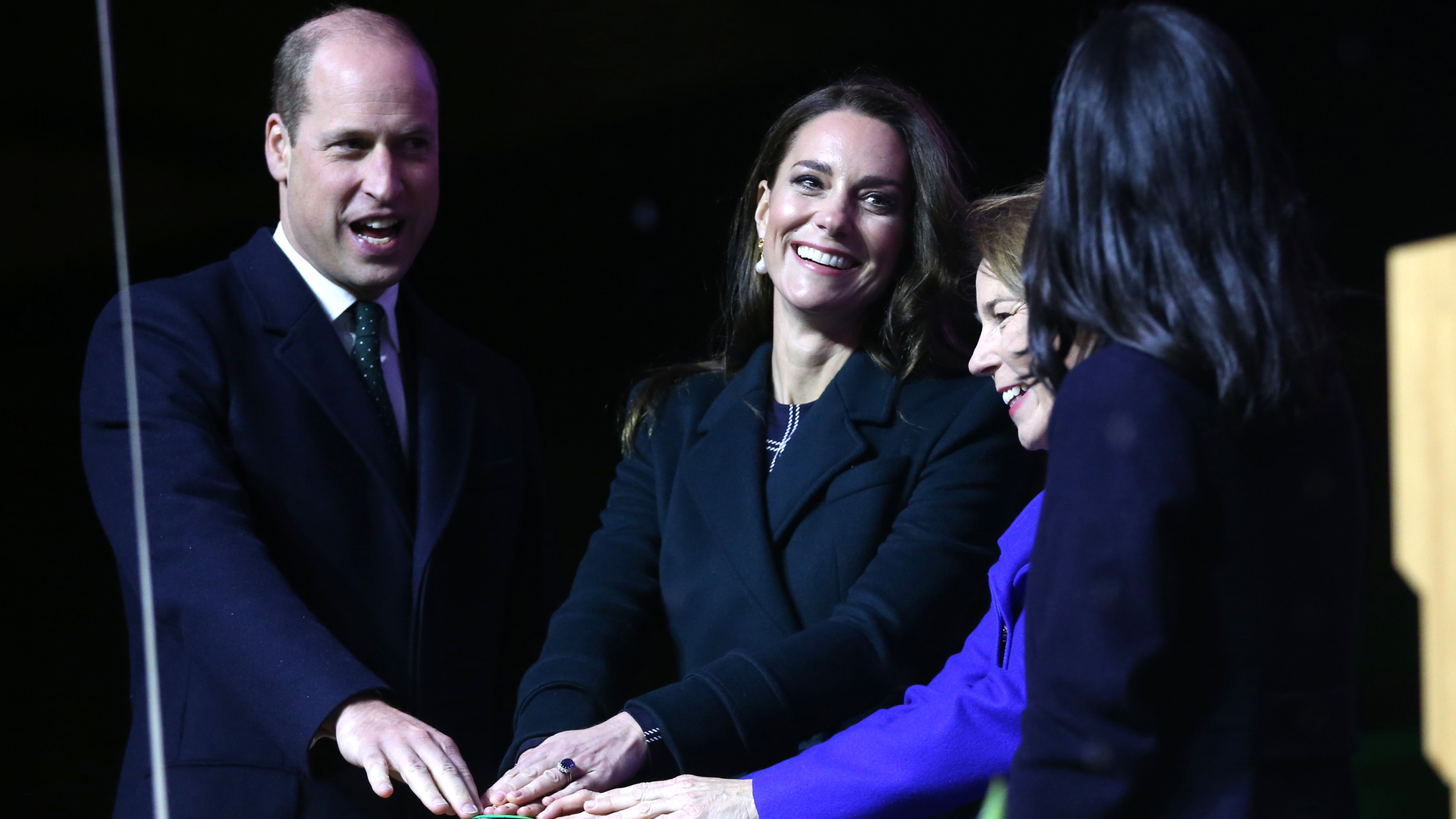 Prince William (from left) and Kate Middleton, Princess of Wales, join Massachusetts Governor-elect Maura Healey and Boston Mayor Michelle Wu in pushing a button to illuminate buildings in Boston in green light Nov. 30.