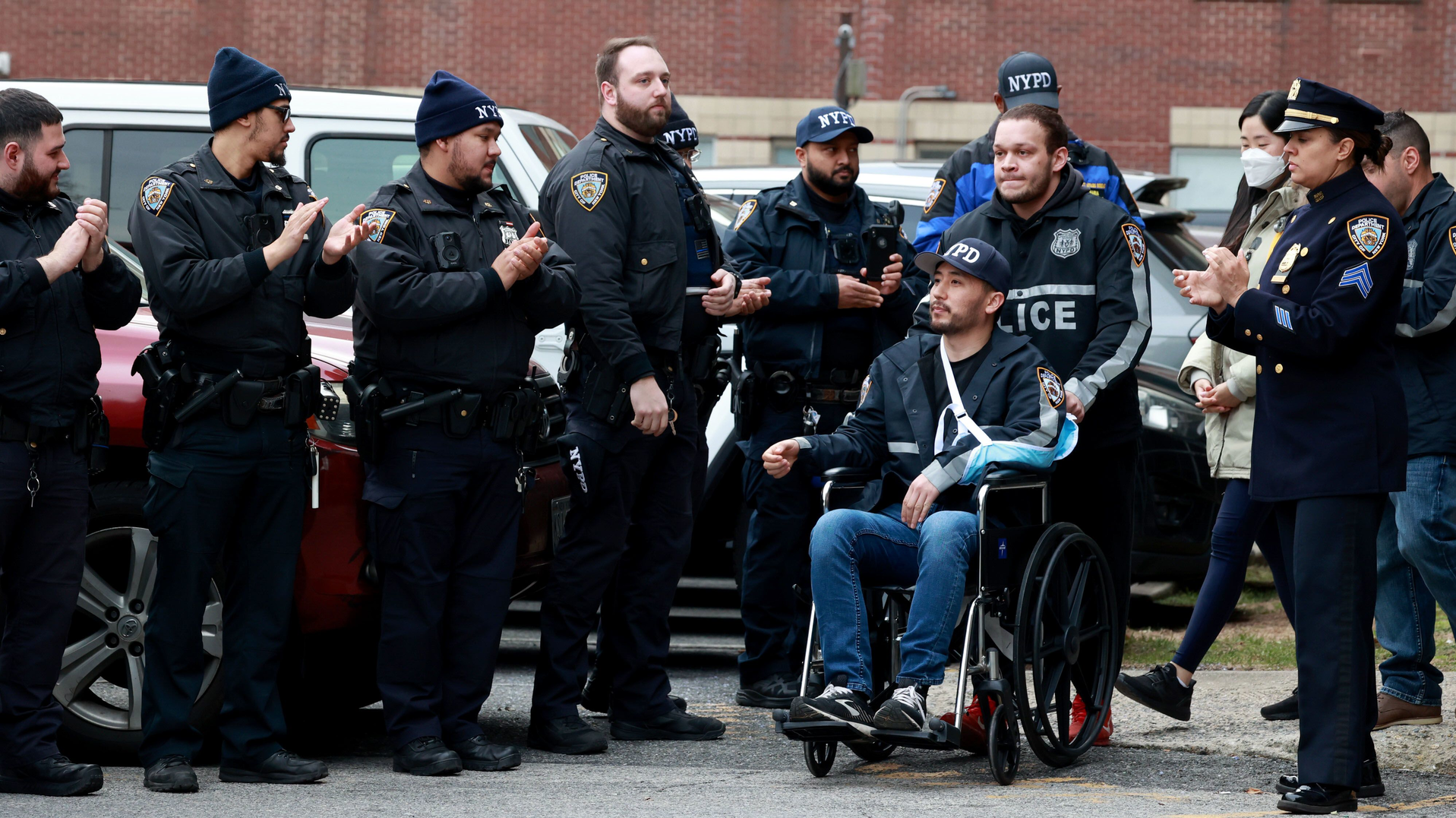NYPD Officer Paul Lee is wheeled by his partner Antonio Martinez during his release from St. Barnabas Hospital in the Bronx on Tuesday.
