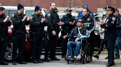 NYPD Officer Paul Lee is wheeled by his partner Antonio Martinez during his release from St. Barnabas Hospital in the Bronx on Tuesday.