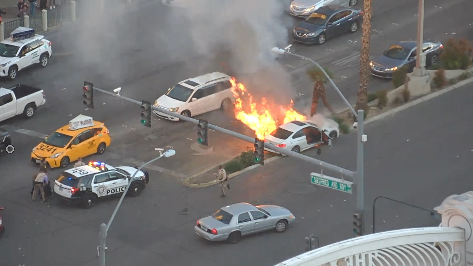 A video posted on social media by police shows a bystander helping the officer pull the driver out of the car just before it caught fire.