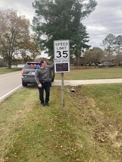 Sheriff Ray Campbell is seen next to the county&apos;s TC-400 radar speed sign.