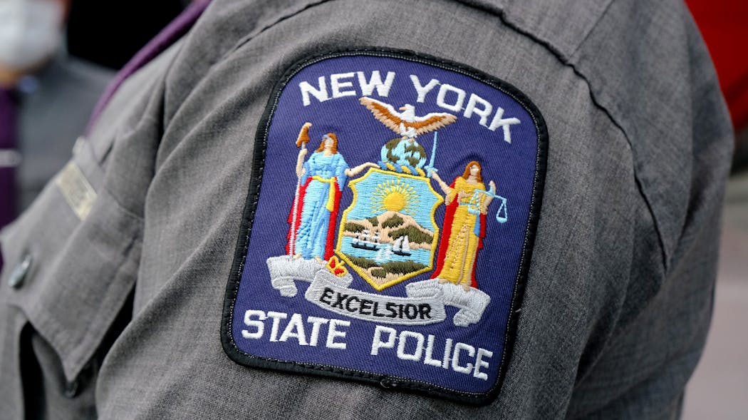 Manhattan - January 13, 2021 - New York State Police patch is seen on a State Trooper arm inside the Jacob Javits Convention Center the newly opened super Covid-19 vaccination hub.