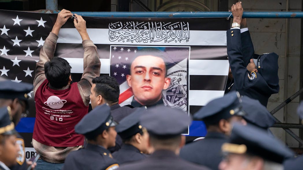 A picture of NYPD officer Adeed Fayaz was displayed outside his funeral at the Makki Masjid Muslim Community Center on Thursday in Midwood, Brooklyn.