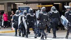 Virginia State Police form in front of a parking garage after a fight clears up to secure an area in Charlottesville in August 2017. Virginia State Police form in front of a parking garage after a fight clears up to secure an area in Charlottesville in August 2017.