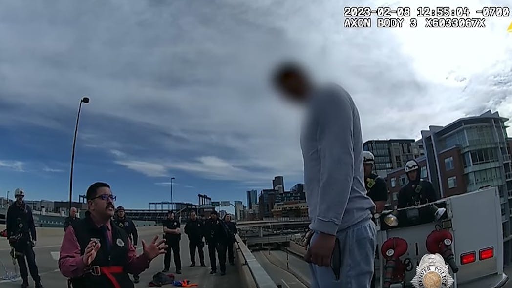Denver Police Det. Rueban Garduno, a department negotiator, tries to talk down a man threatening to jump from a bridge Wednesday, seconds before officers and firefighters grabbed him as he leaped off the edge of the overpass. Denver Police Det. Rueban Garduno, a department negotiator, tries to talk down a man threatening to jump from a bridge Wednesday, seconds before officers and firefighters grabbed him as he leaped off the edge of the overpass.