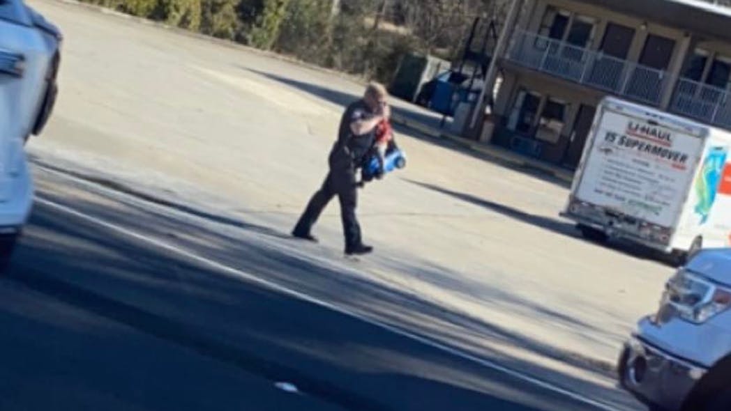 Gadsden, AL, Police Lt. Josh Russell rescued a child who rode a toy car onto a busy highway during the lunchtime rush Friday. Gadsden, AL, Police Lt. Josh Russell rescued a child who rode a toy car onto a busy highway during the lunchtime rush Friday.