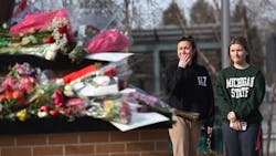 People visit the Spartan statue on the campus of Michigan State University in East Lansing on Tuesday after a gunman opened fire at two locations on the campus Monday night, killing three students and injuring several others. People visit the Spartan statue on the campus of Michigan State University in East Lansing on Tuesday after a gunman opened fire at two locations on the campus Monday night, killing three students and injuring several others.