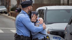 A Philadelphia police officer is consoled Monday after a visit to the memorial for Temple University Police Officer Christopher Fitzgerald, who was shot and killed in the line of duty Saturday. A Philadelphia police officer is consoled Monday after a visit to the memorial for Temple University Police Officer Christopher Fitzgerald, who was shot and killed in the line of duty Saturday.