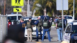 Law enforcement personnel stand outside Eric White Elementary School after a shooting incident nearby on Tuesday, Jan. 31, 2023, in Selma, California.