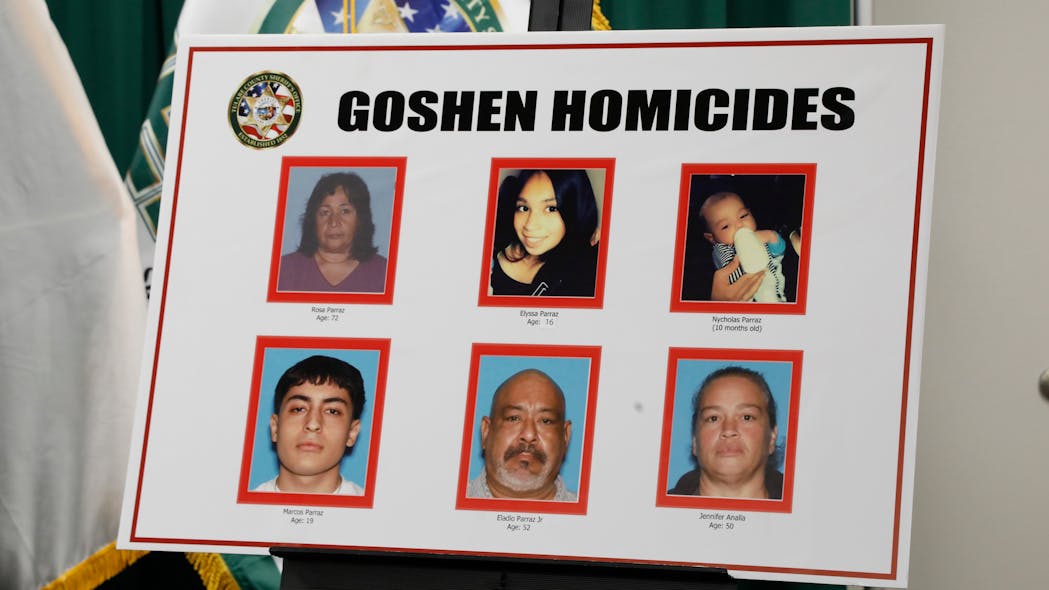 Tulare County Sherriff Mike Boudreaux holds a news conference in Visalia, California, on Jan. 17, 2023, regarding the shooting of six people in nearby Goshen. A poster of the victims of the Goshen homicides is displayed at the news conference after six people were killed at a home in Goshen over the MLK holiday weekend.
