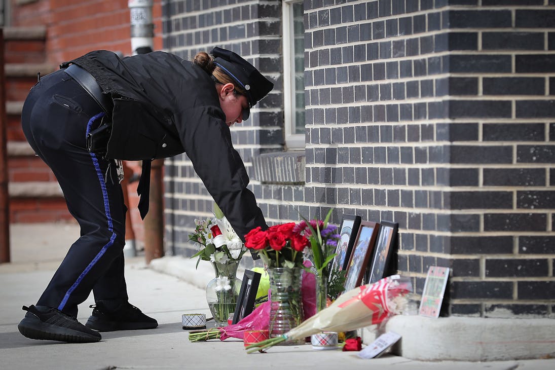 A Philadelphia police officer, who didn t want to give their name, leaves flowers Sunday at a memorial for Christopher Fitzgerald, the fallen Temple University police officer, near 17th Street and Montgomery Avenue in Philadelphia. The police officer said she went through the police academy with Fitzgerald.
