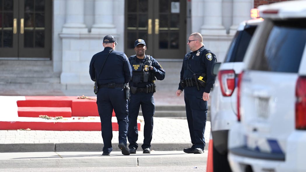 Denver police investigate the scene of a shooting at East High School on Wednesday that left two deans wounded.