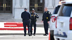 Denver police investigate the scene of a shooting at East High School on Wednesday that left two deans wounded.