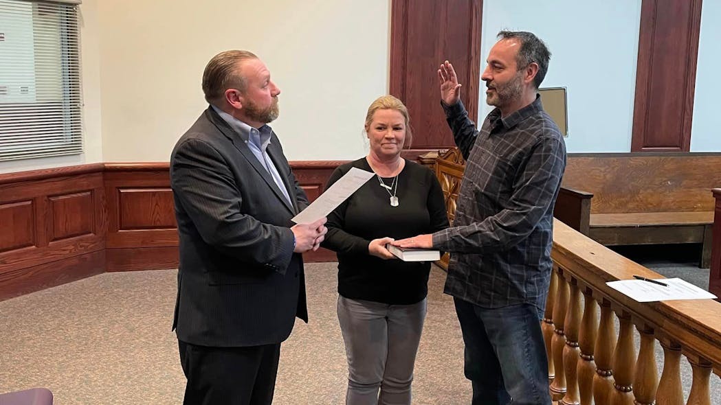 Matthew Shahnavaz was sworn in Wednesday as a reserve officer for the Elwood, IN, Police Department, and he will carry the badge number of his son, Noah, who was fatally shot during a July traffic stop.