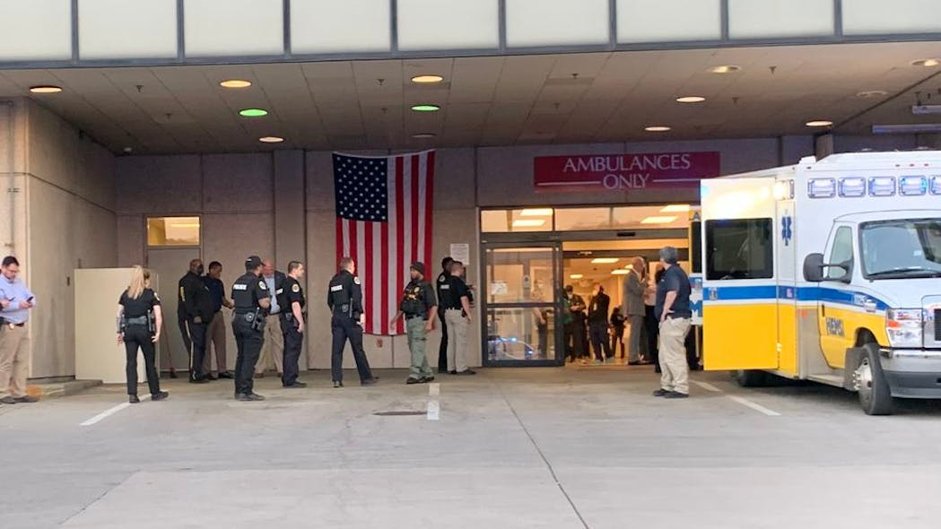 Law enforcement officers and first responders arrive at Huntsville Hospital after two Huntsville, AL, police officers and a civilian were shot Tuesday.