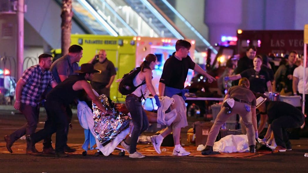 An injured person is tended to in the intersection of Tropicana Avenue and Las Vegas Boulevard after a mass shooting at a country music festival nearby on Oct. 2, 2017 in Las Vegas.