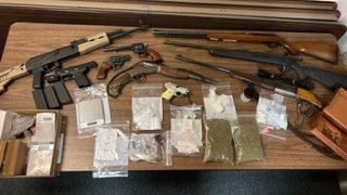 A drug investigation led Huntingdon, PA, police Thursday to an apartment behind the department's station, where they found five children, along with guns, explosives and drugs.