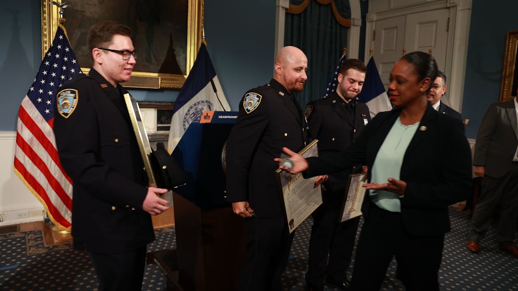 NYPD Officers Luis A. Iorio (from left) and Mickel G. Hanna, both of the 123rd Precinct; and Officer Paul J. Cozzolino, 50th Precinct were honored at New York City Hall on Wednesday. NYPD Officers Luis A. Iorio (from left) and Mickel G. Hanna, both of the 123rd Precinct; and Officer Paul J. Cozzolino, 50th Precinct were honored at New York City Hall on Wednesday.
