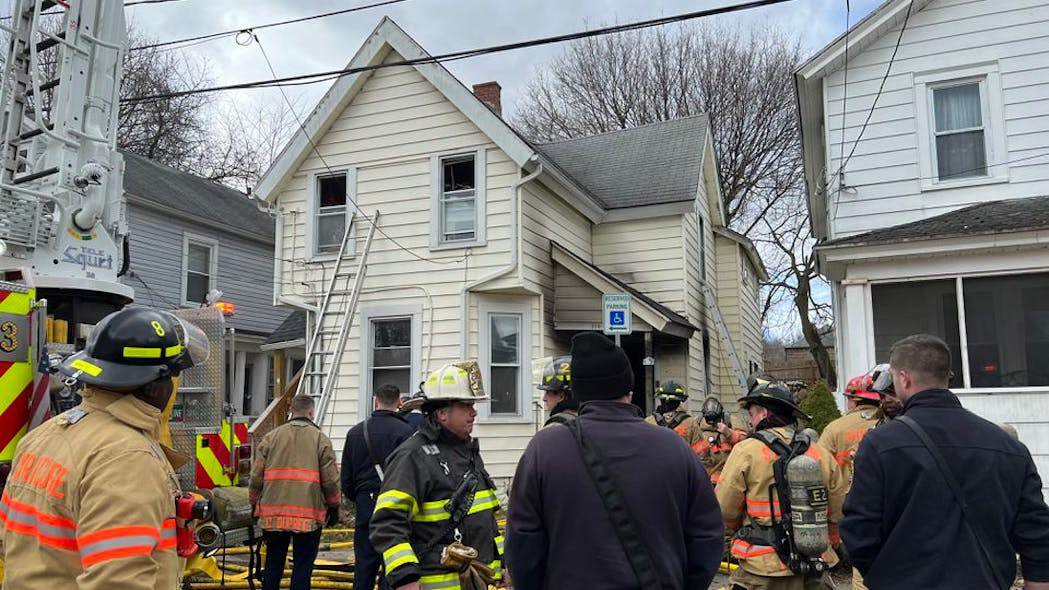 A Syracuse, NY, police officer rushed into a burning house to alert six residents inside to get out Friday. A Syracuse, NY, police officer rushed into a burning house to alert six residents inside to get out Friday.