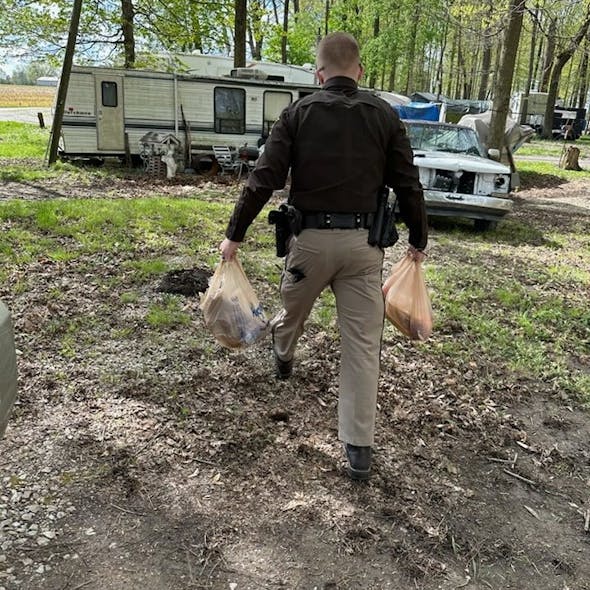 Hancock County, IN, Sheriff's Deputy Josh Cochard delivered groceries for a woman on April 20. He had stopped her while she was traveling an unsafe route to the store on her electric scooter.