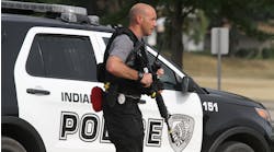 An Indianola, IA, police officer carries a rifle during an active shooter training session in 2018.
