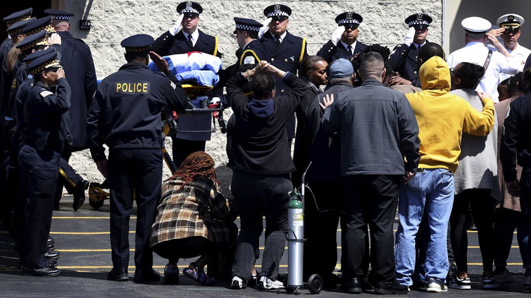 Officers salute and family members stand in silence as the casket of Chicago Police Officer Ar&eacute;anah Preston is carried into toward Blake-Lamb Funeral Home in Oak Lawn Tuesday.