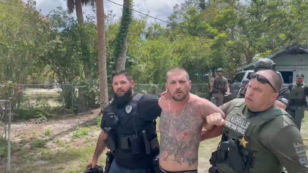 U.S. Marshals apprehend Ryan Lee Pope who was hiding behind a make-shift wall inside a home in Arcadia, FL, after ramming the cruiser of a DeSoto County sheriff's detective. U.S. Marshals apprehend Ryan Lee Pope who was hiding behind a make-shift wall inside a home in Arcadia, FL, after ramming the cruiser of a DeSoto County sheriff's detective.