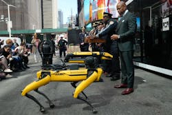 New York City Mayor Eric Adams looks at Boston Dynamics&apos; Spot for Public Safety during an April press conference.