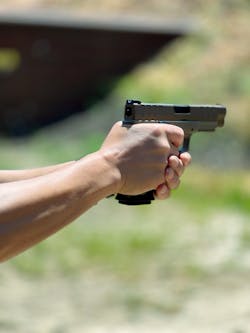 A close-up of the gun shows the striker status indicator. A close-up of the gun shows the striker status indicator.