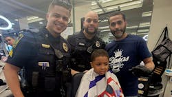 A young man receives a trim as part of East Hartford, CT, Police Department's Haircut With a Cop program Monday. A young man receives a trim as part of East Hartford, CT, Police Department's Haircut With a Cop program Monday.